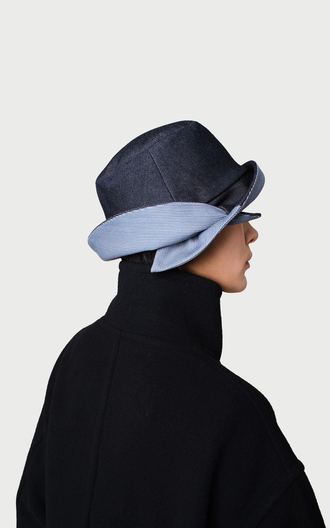 A Side / B Side Cross-brim Bucket Hat worn by a model